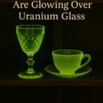 Glowing green uranium glass goblets and serving ware under blacklight, styled for a vintage estate sale by Triumphant Estate Sales Los Angeles.